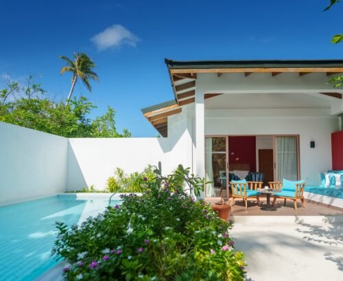 Beach Suite private plunge pool with outdoor turquoise seating and open living area at Joy Island Maldives under clear blue sky in North Malé Atoll