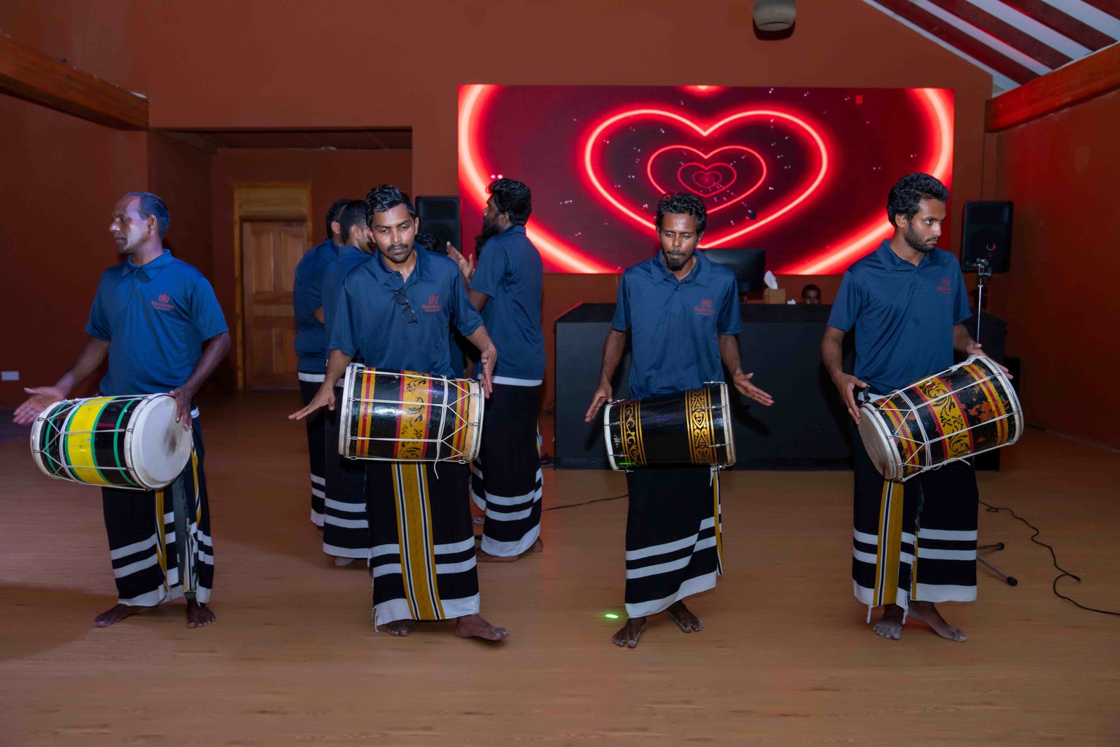 Traditional Maldivian boduberu drum performers in cultural attire performing on stage at Brennia Kottefaru Maldives during an evening entertainment show