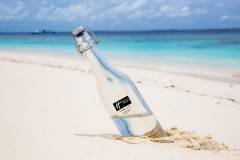 Bottle,With,Water,Located,In,The,Sand,On,The,Beach